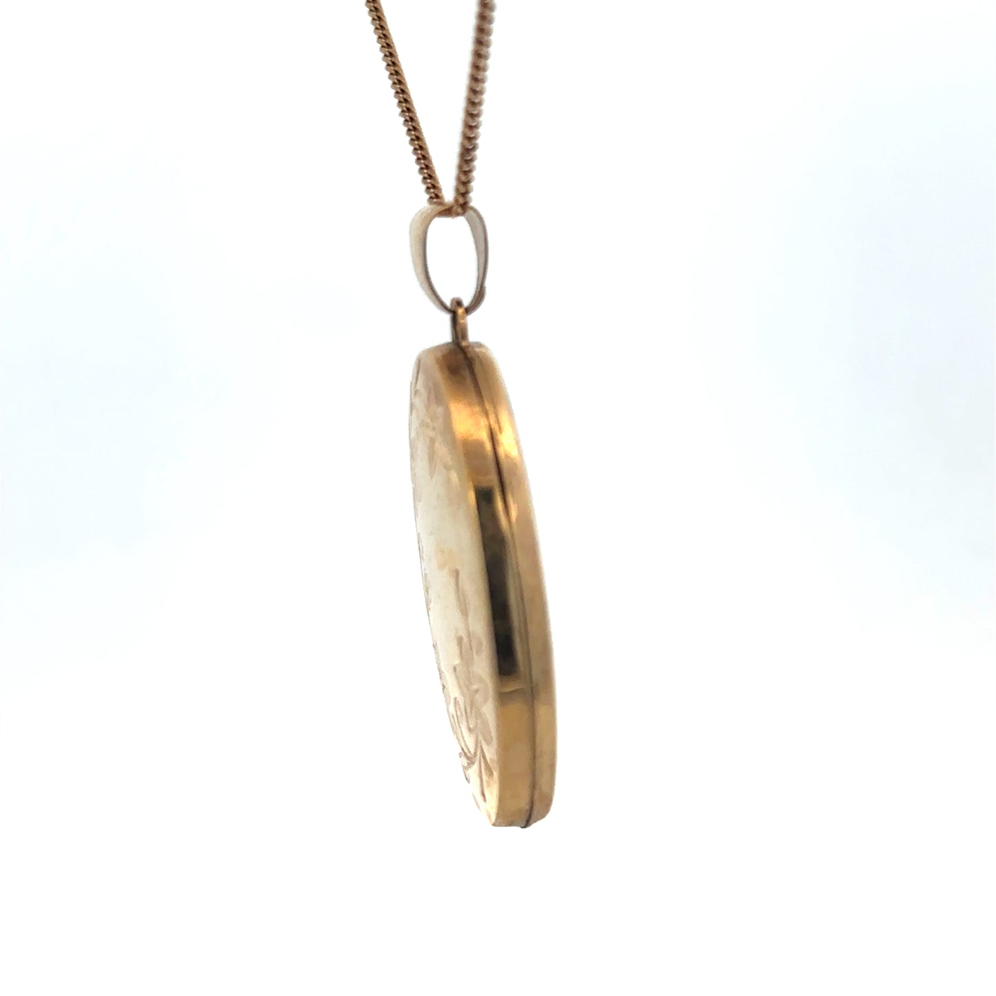 Reeves and Sons 9ct yellow gold locket pendant with floral engraved design, weighs 4.2g, shown on a jewelry display stand.