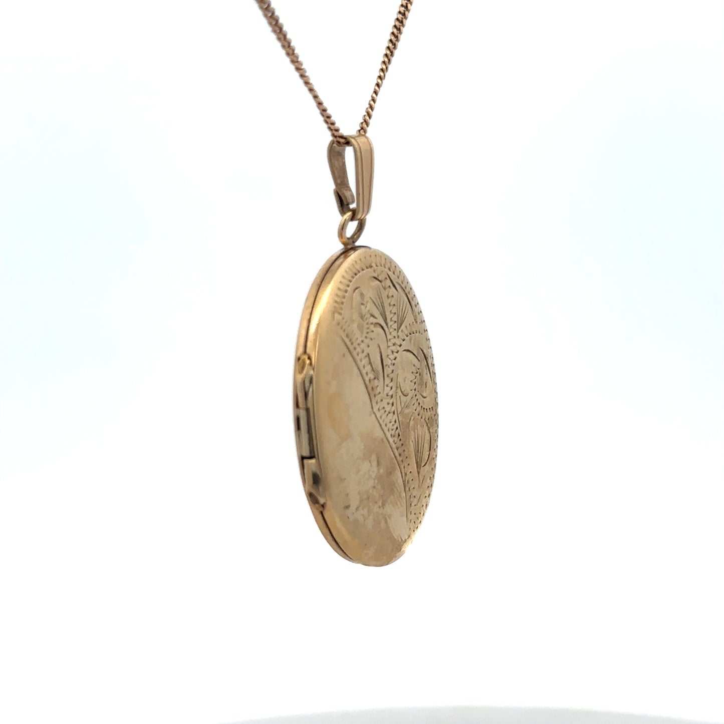 9ct yellow gold locket pendant by Reeves and Sons, 5.4g, featuring a classic design with intricate detailing.