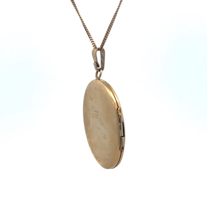 9ct yellow gold locket pendant weighing 5.4g by Reeves and Sons, featuring a classic design and polished finish.