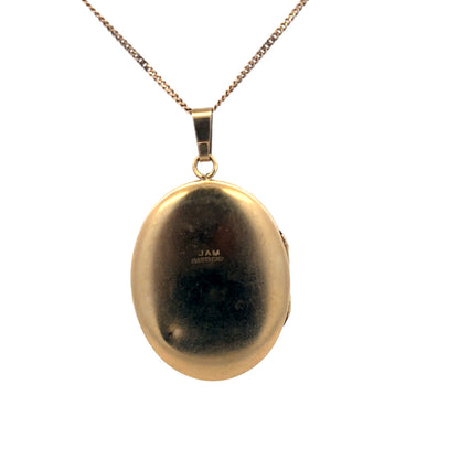 9ct yellow gold locket pendant by Reeves and Sons, weighing 5.4g, featuring intricate design in a close-up view.