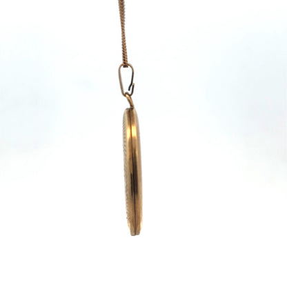 9ct yellow gold pendant locket by Reeves and Sons, showcasing a detailed design and polished finish.