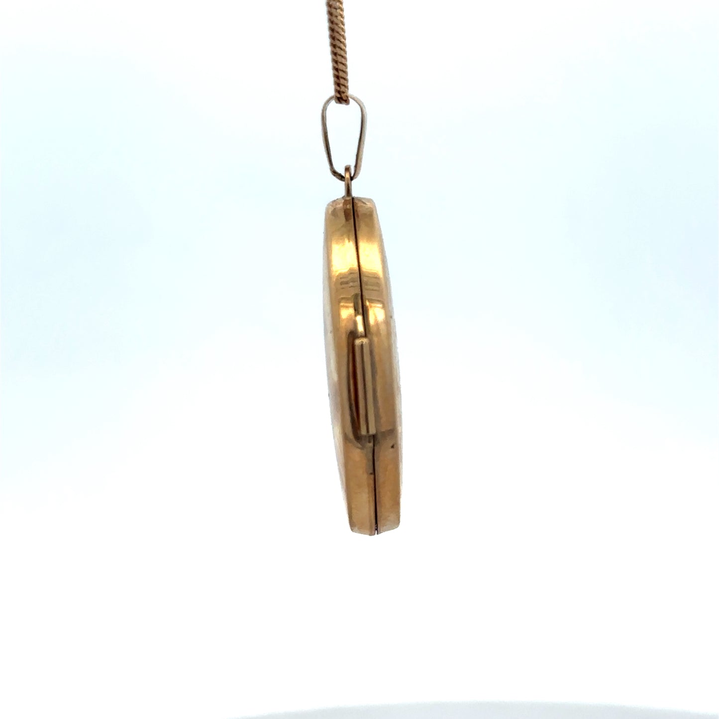 9ct yellow gold locket pendant by Reeves and Sons, 4.4g, featuring intricate design and polished finish.