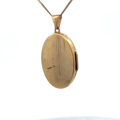 9ct yellow gold locket pendant by Reeves and Sons, featuring a detailed design, weighing 4.4g, shown in close-up view.