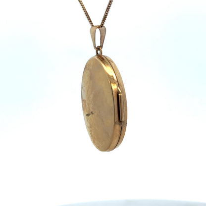 9ct yellow gold locket pendant by Reeves and Sons, 4.4g, detailed close-up showing intricate design and polished finish.