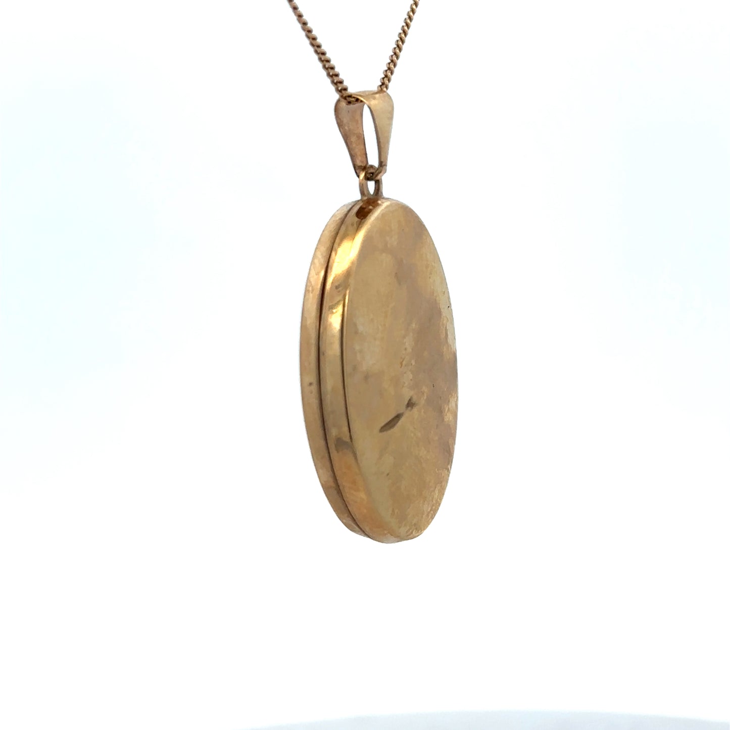 9ct yellow gold locket pendant by Reeves and Sons, intricate design, weighs 4.4g, shown close-up with detailed craftsmanship.