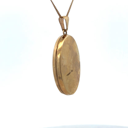 9ct yellow gold locket pendant by Reeves and Sons, intricate design, weighs 4.4g, shown close-up with detailed craftsmanship.