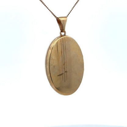 9ct yellow gold locket pendant by Reeves and Sons, featuring intricate design, weight 4.4g, in a close-up image.