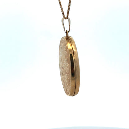 9ct yellow gold locket pendant by Reeves and Sons, featuring intricate design, weight 4.4g, shown in close-up image.