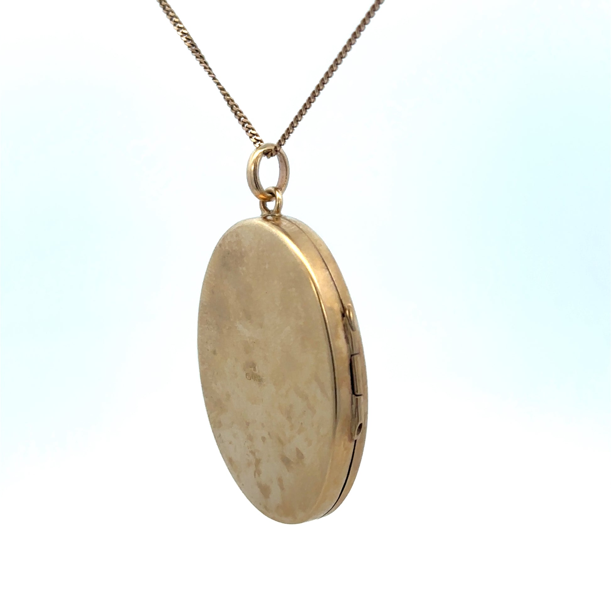 9ct yellow gold locket pendant with intricate design, weighing 9.3g, from Reeves and Sons.
