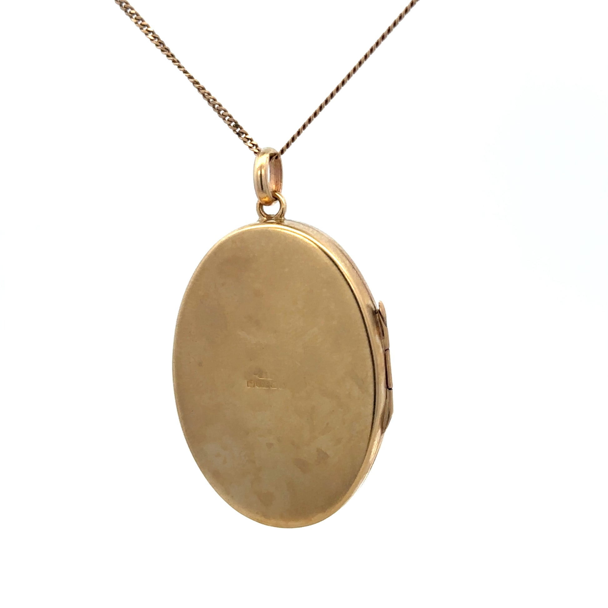 9ct yellow gold locket pendant by Reeves and Sons, featuring intricate design, weight 9.3g, shown in close-up image.