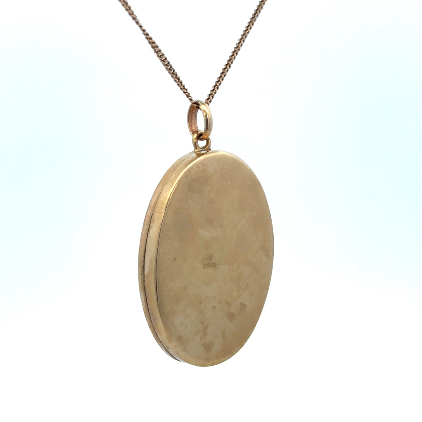 9ct yellow gold locket pendant with intricate engraving, weighing 9.3g, from Reeves and Sons, featuring a classic and elegant design.