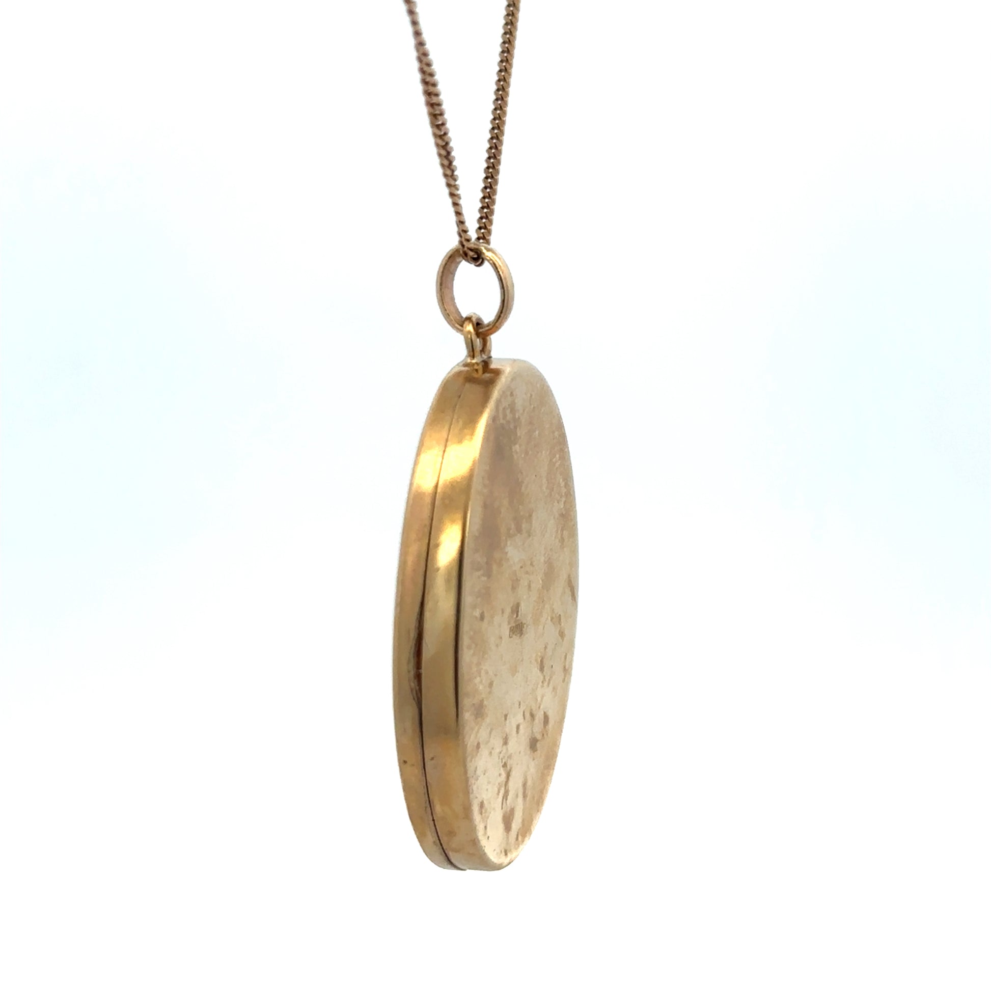 9ct yellow gold locket pendant with intricate design, weighing 9.3g, by Reeves and Sons, shown in close-up detail.