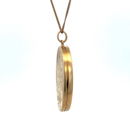 9ct yellow gold locket pendant by Reeves and Sons, showcasing a polished oval design with intricate detailing.