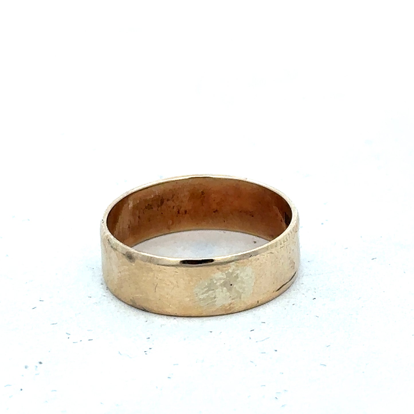 9ct yellow gold band ring in size P1/2 with smooth finish, crafted by Reeves and Sons, shown on a white background.