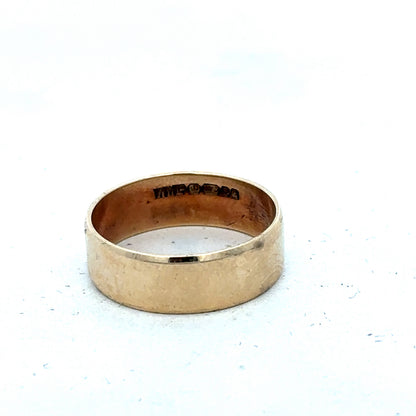 9ct yellow gold band ring in size P1/2, smooth polished surface, from Reeves and Sons.
