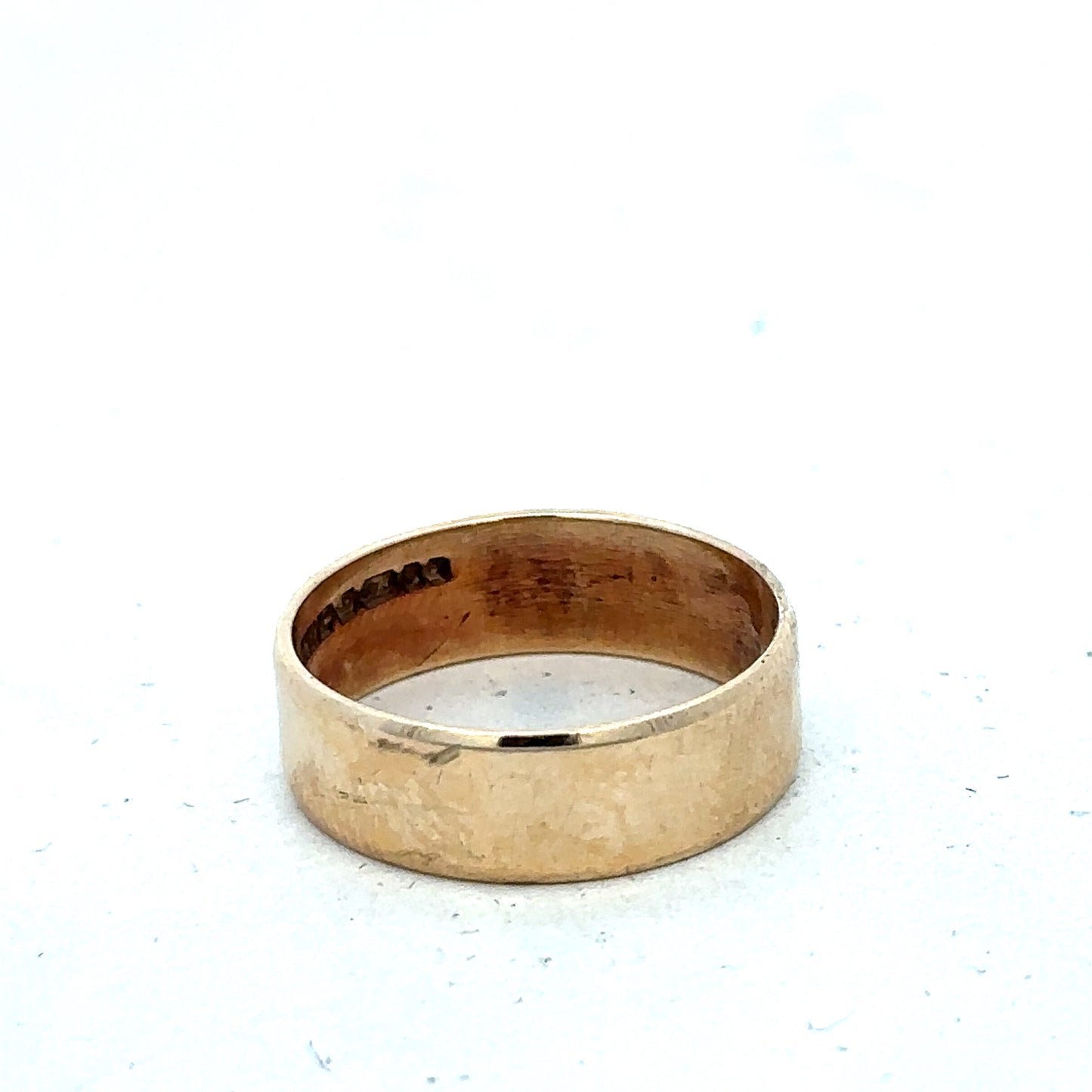 9ct yellow gold band ring in size P1/2 with Reeves and Sons branding, featuring a smooth polished finish and classic design.