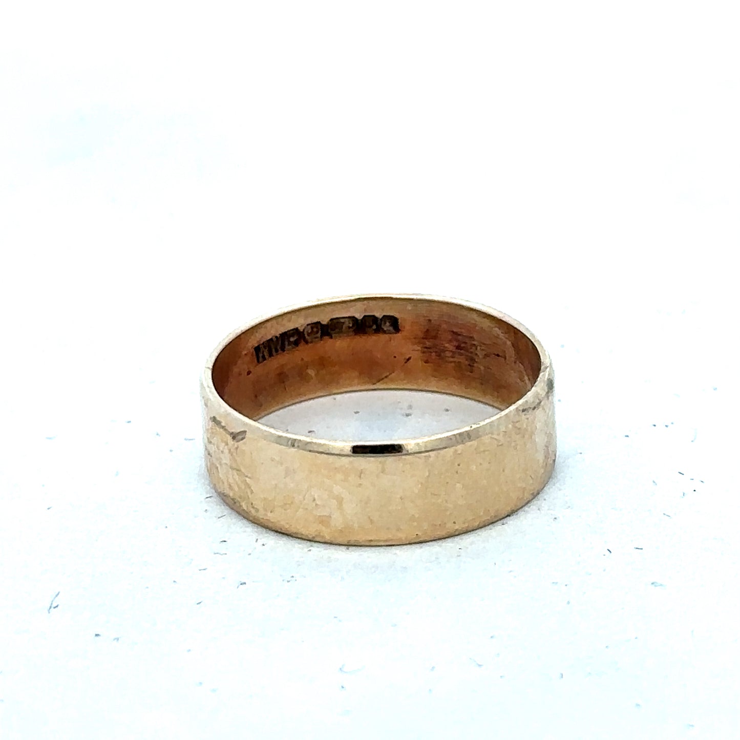 9ct yellow gold band ring in size P1/2, Reeves and Sons jewelry, close-up of smooth polished gold band.