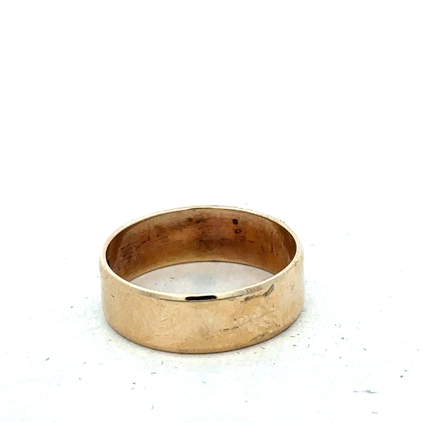9ct yellow gold band ring in size P1/2 by Reeves and Sons, close-up showing smooth polished surface and rounded edges.