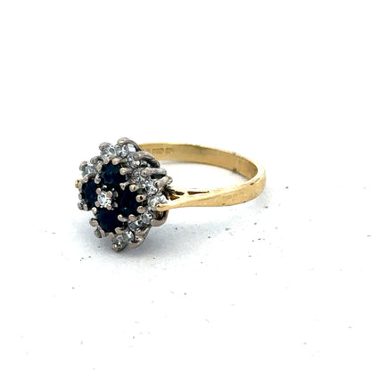 18ct yellow gold ring with diamonds and sapphires, size H, by Reeves and Sons, featuring a detailed gemstone design.