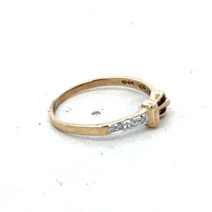 9ct yellow gold buckle ring in size M 1/2 by Reeves and Sons, detailed close-up showing polished gold finish and buckle design.