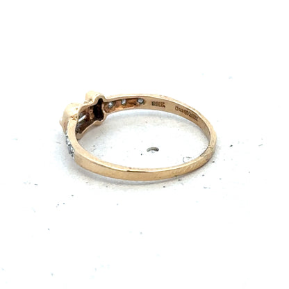 9ct yellow gold buckle ring in size M 1/2 by Reeves and Sons, featuring a detailed buckle design on a plain band.