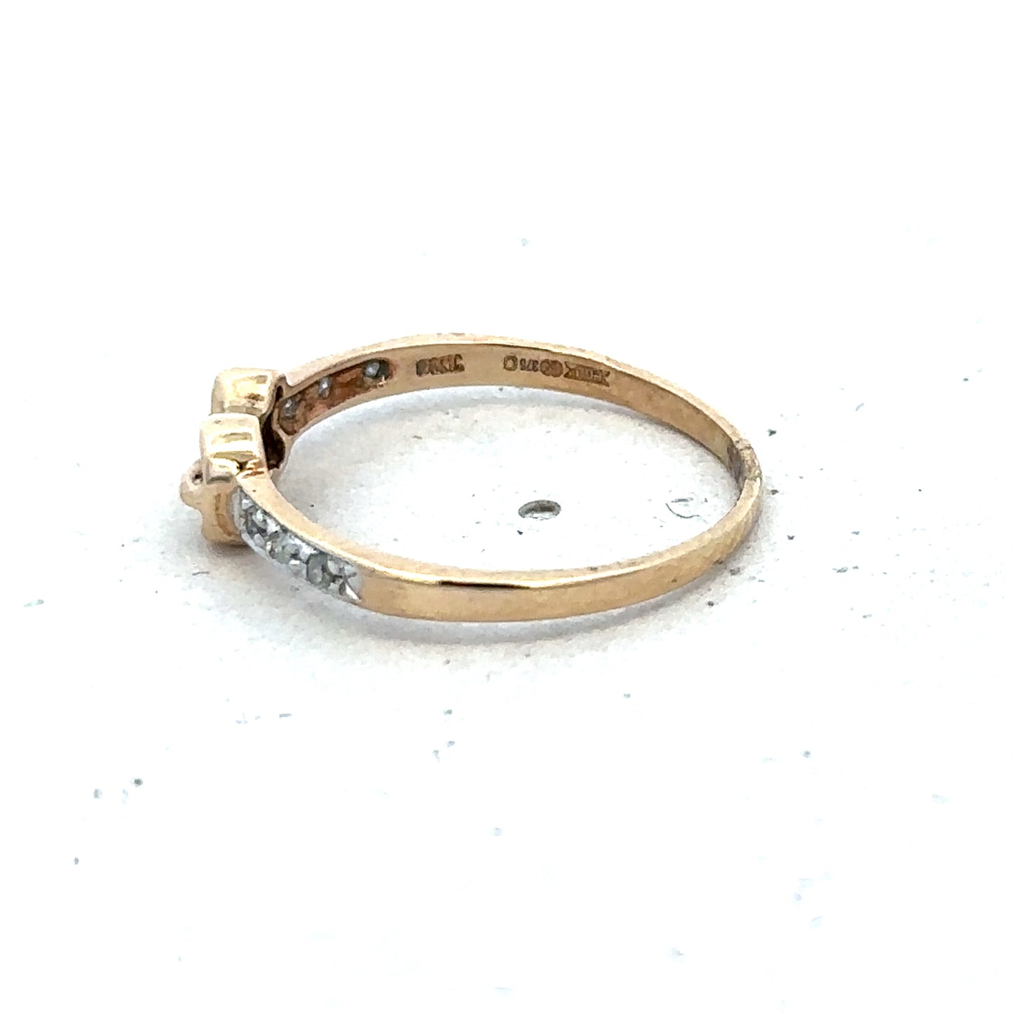 9ct yellow gold buckle ring in size M 1/2 with a polished finish, designed by Reeves and Sons.