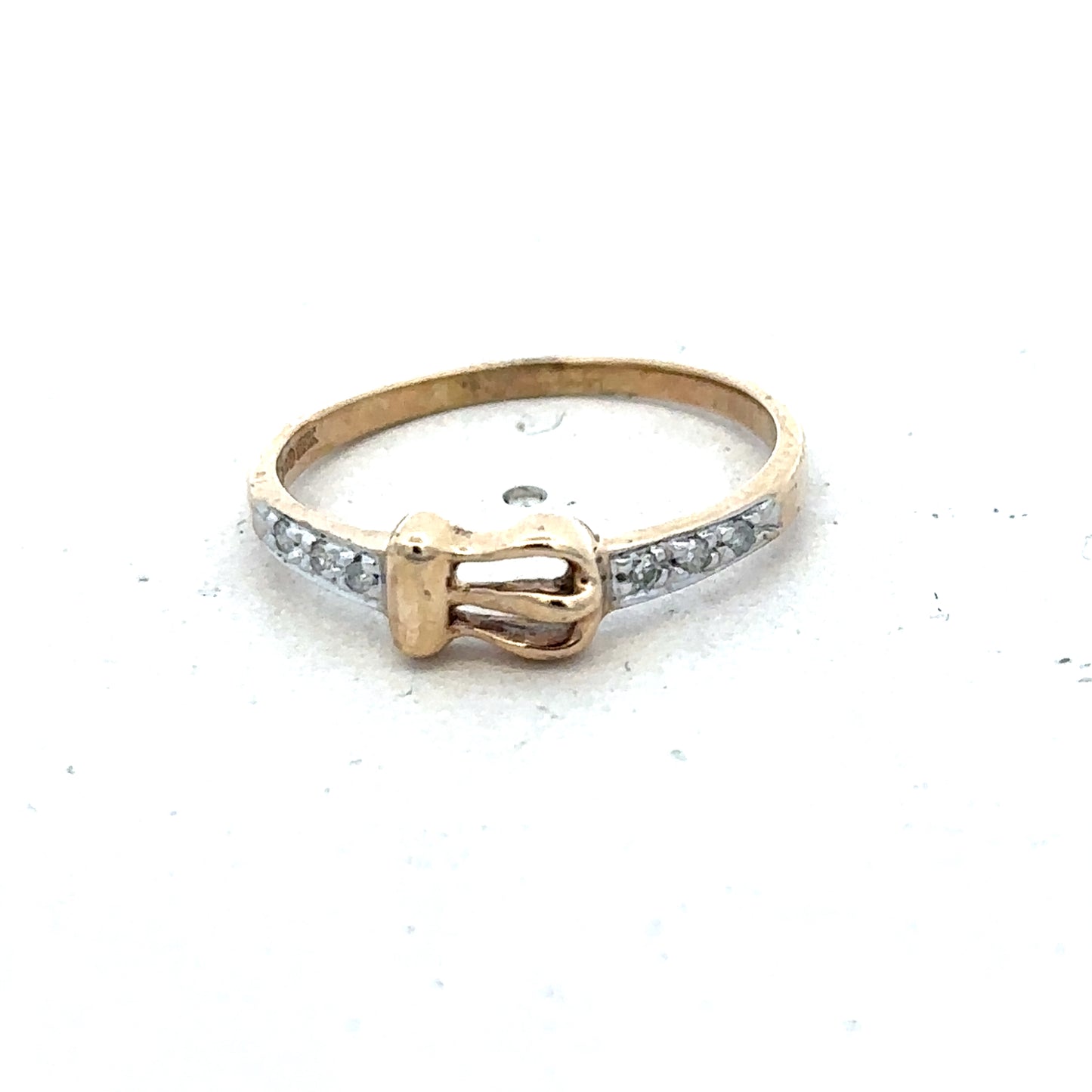 9ct yellow gold buckle ring in size M 1/2 with a polished finish, featuring a textured buckle design, by Reeves and Sons.