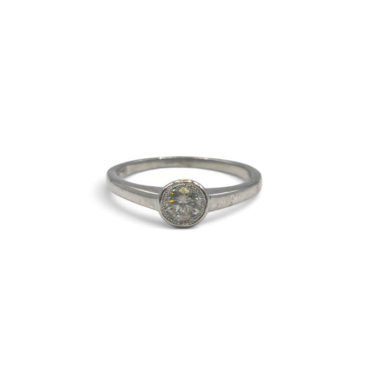 18ct white gold diamond solitaire ring by Reeves and Sons, featuring a sparkling central diamond on a sleek band.