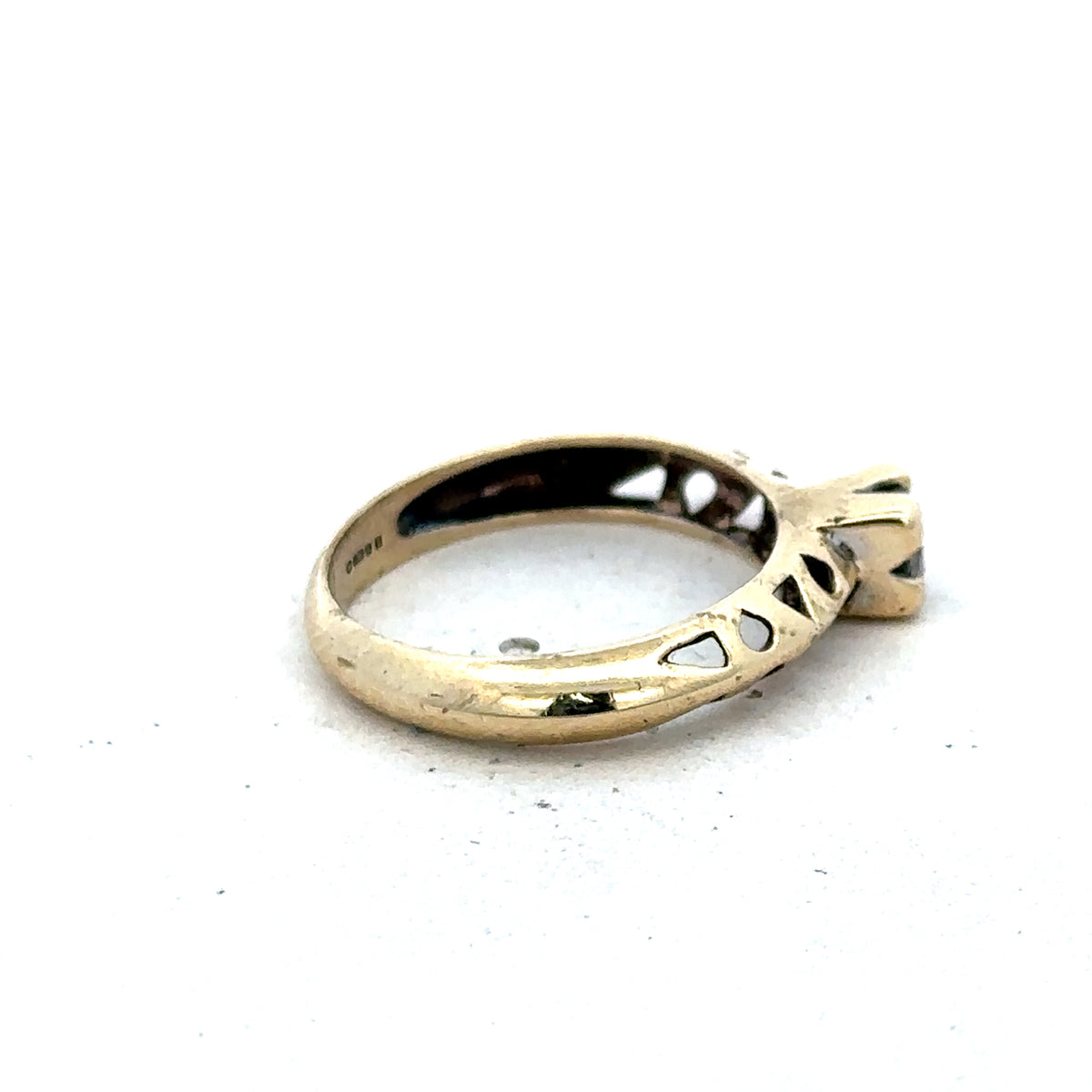 9ct yellow gold ring size M by Reeves and Sons, showcasing a smooth, polished band with a subtle shine.