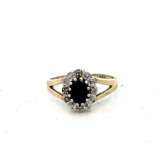 9ct yellow gold sapphire and diamond ring in size K, featuring a central sapphire with diamond accents, by Reeves and Sons.