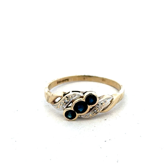 9ct yellow gold sapphire and diamond ring in size L, Reeves and Sons, showcasing the detailed gemstone setting and elegant design.