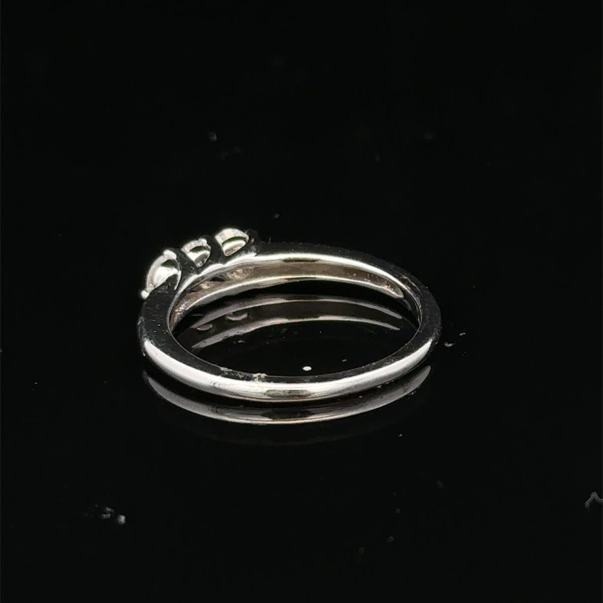 18ct white gold diamond ring by Reeves and Sons with sparkling diamonds and intricate design, photographed against a neutral background.