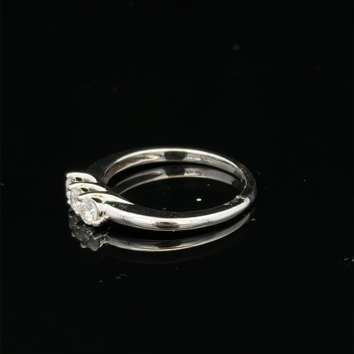 18ct white gold diamond ring by Reeves and Sons featuring sparkling diamonds and a sleek, elegant design.
