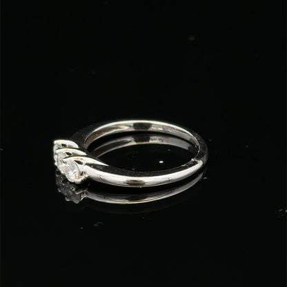 18ct white gold diamond ring by Reeves and Sons featuring sparkling diamonds and a sleek, elegant design.