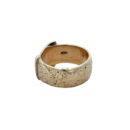 9ct yellow gold buckle ring in size T1/2 with Reeves and Sons branding, featuring a polished gold finish and buckle design.