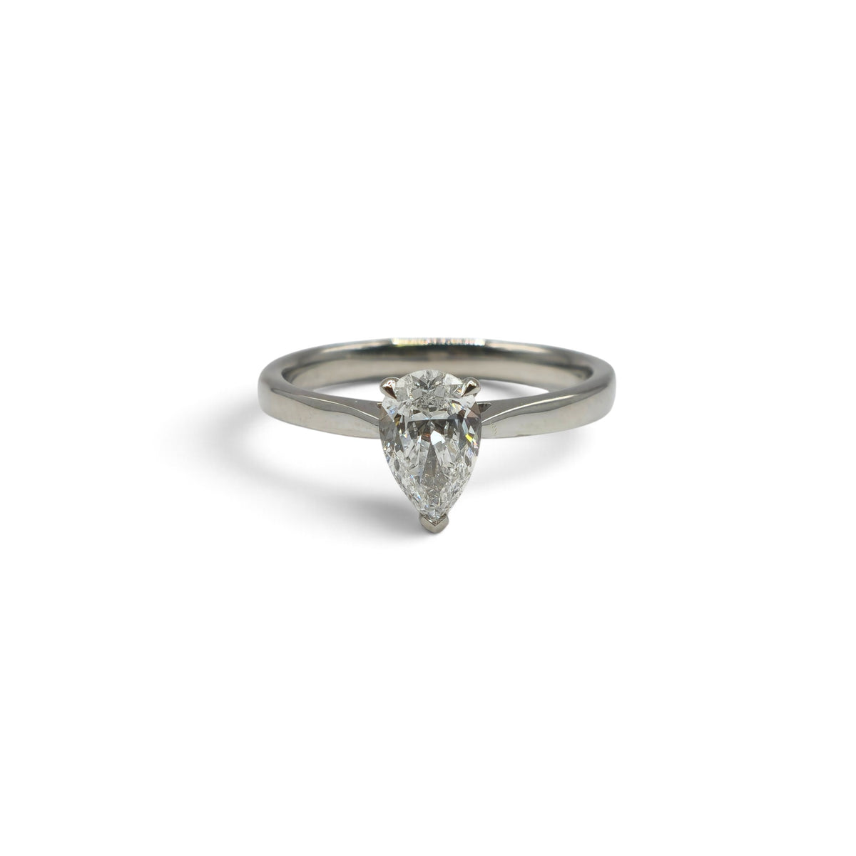 Diamond platinum ring by Reeves and Sons featuring a sparkling diamond set in a sleek platinum band.