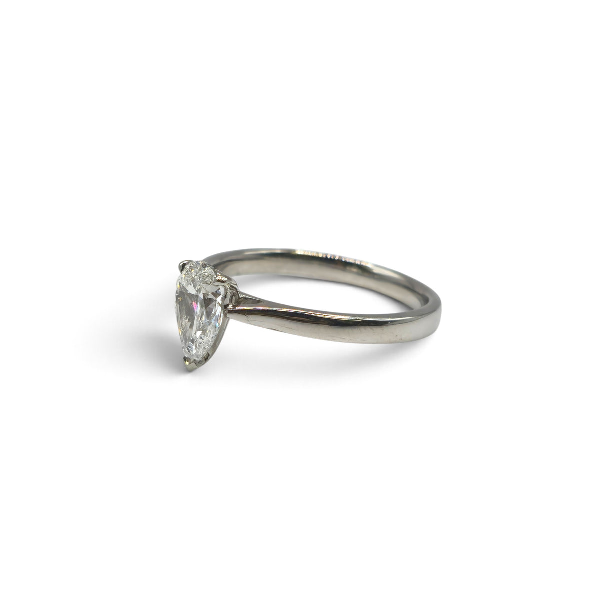 Diamond platinum ring by Reeves and Sons featuring a sparkling central diamond and a sleek, polished band.