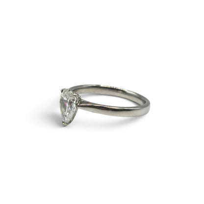 Diamond platinum ring by Reeves and Sons featuring a sparkling central diamond and a sleek, polished band.