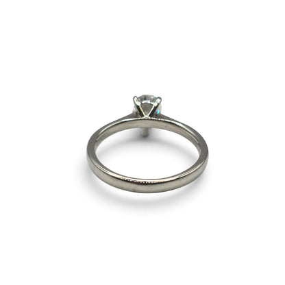 Diamond platinum ring by Reeves and Sons, showcasing a sparkling diamond set in a sleek platinum band.