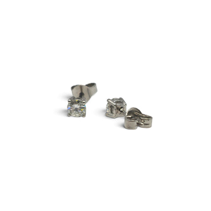 Reeves and Sons platinum diamond stud earrings with sparkling diamonds on a white background.