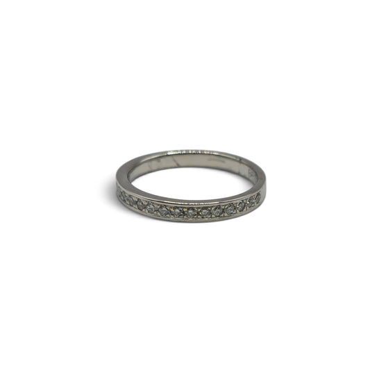 Reeves and Sons platinum half eternity diamond ring with alternating round-cut diamonds and sleek band design.