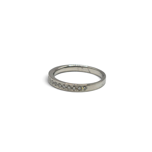 Platinum half eternity diamond ring by Reeves and Sons showcasing a band with sparkling diamonds and a polished finish.