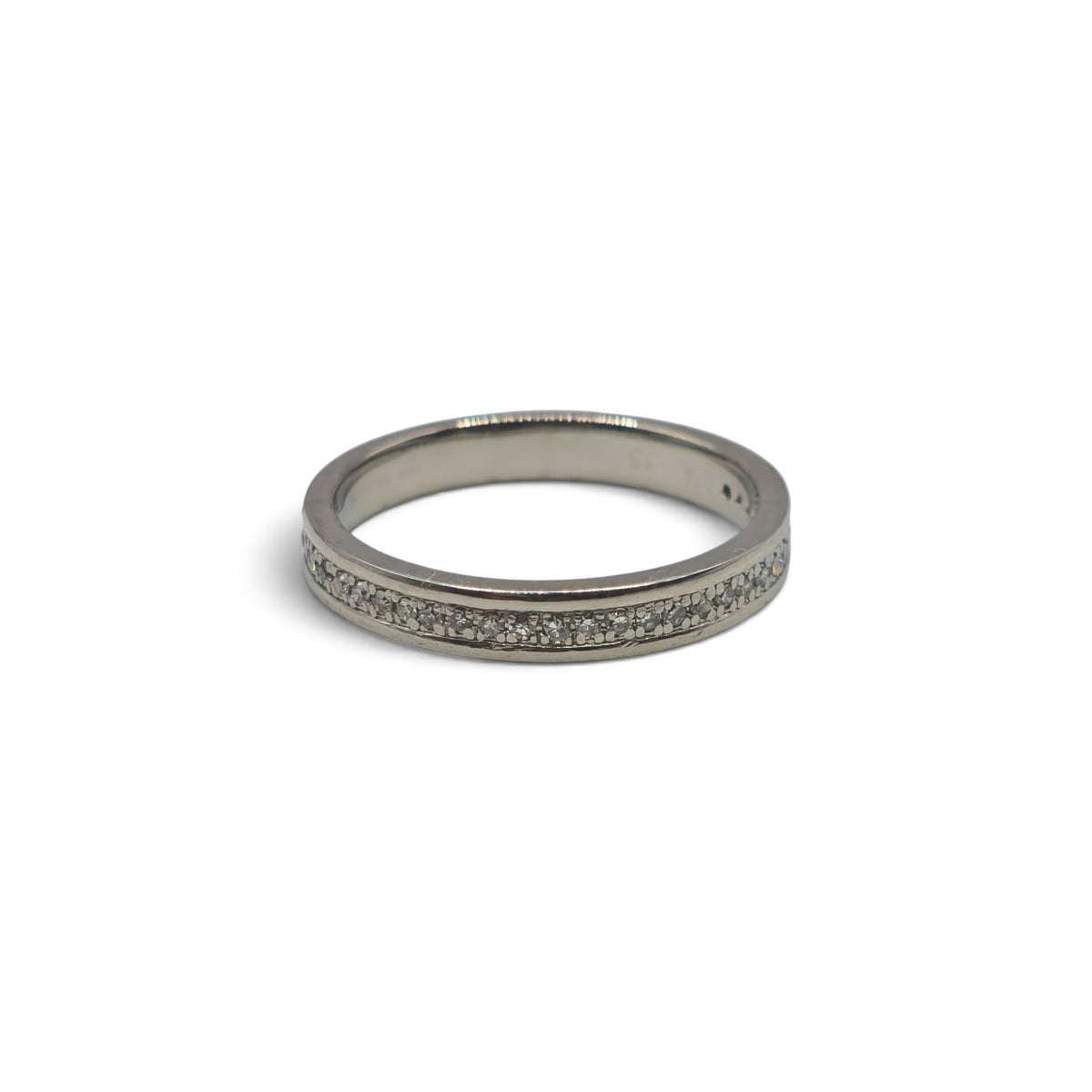 Platinum diamond half eternity ring by Reeves and Sons featuring a band with sparkling diamonds and intricate design.