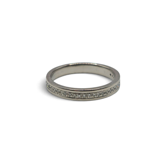 Platinum diamond half eternity ring by Reeves and Sons featuring a band with sparkling diamonds and intricate design.