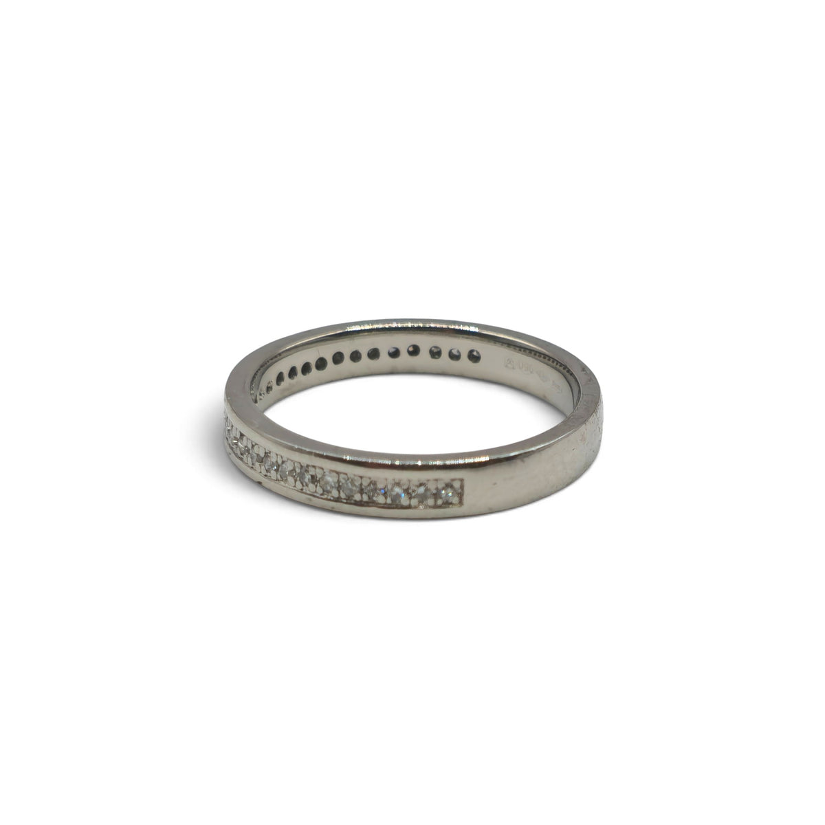 Platinum diamond half eternity ring by Reeves and Sons featuring a row of sparkling diamonds around the band.