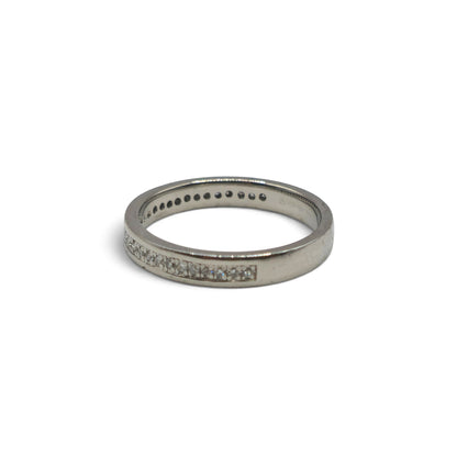 Platinum diamond half eternity ring by Reeves and Sons featuring a row of sparkling diamonds around the band.