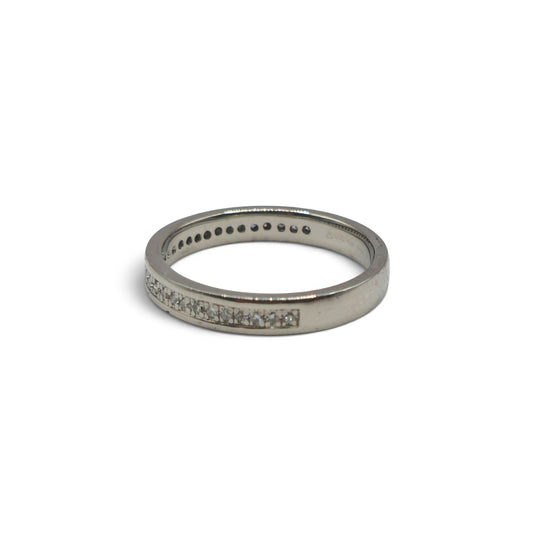Platinum diamond half eternity ring by Reeves and Sons featuring a row of sparkling diamonds around the band.