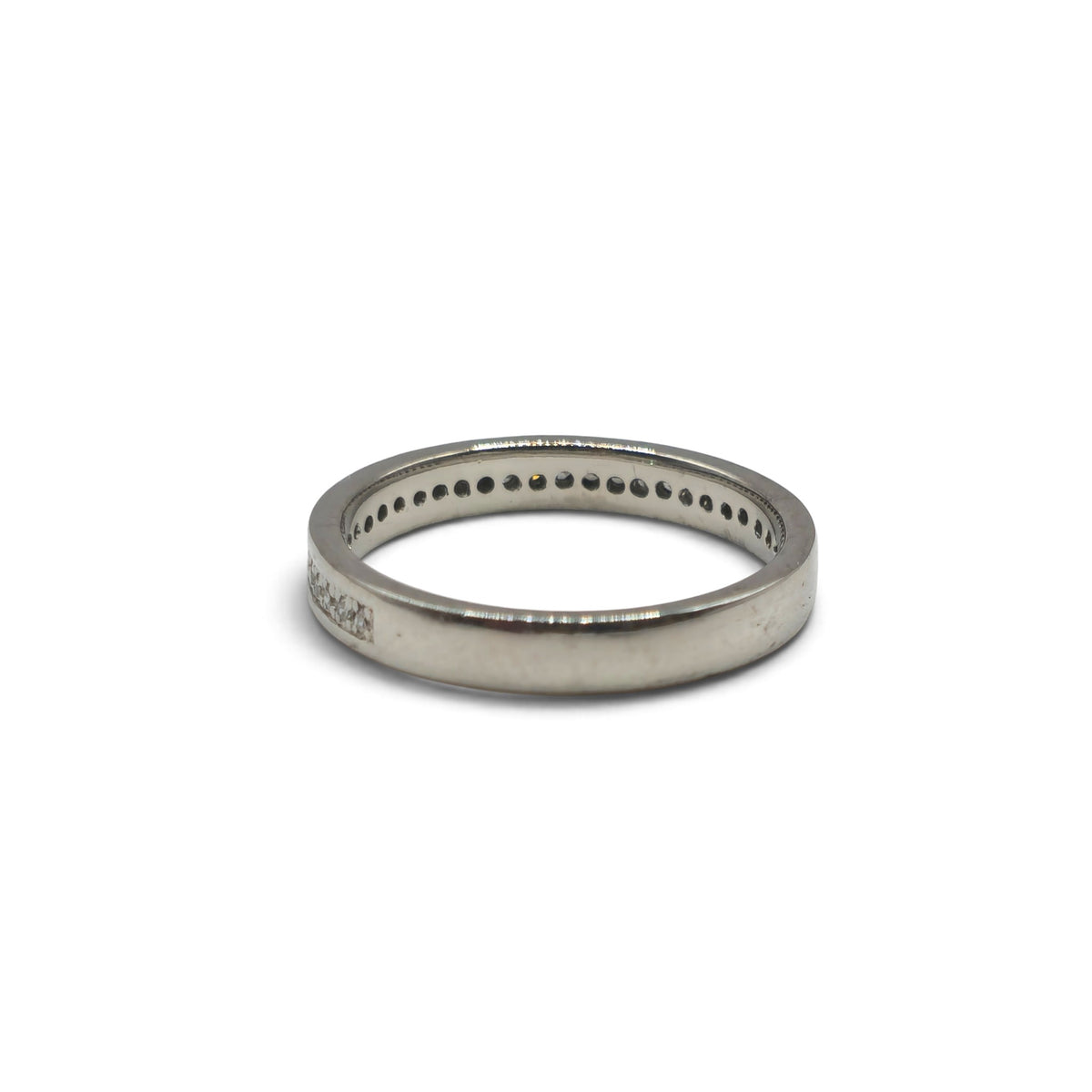 Platinum diamond half eternity ring by Reeves and Sons, featuring sparkling diamonds set in a sleek band.
