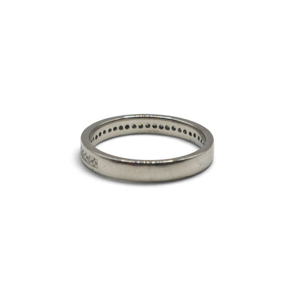 Platinum diamond half eternity ring by Reeves and Sons, featuring sparkling diamonds set in a sleek band.