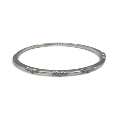 18ct white gold diamond bangle by Reeves and Sons, showcasing a sleek design with sparkling diamonds on a polished surface.